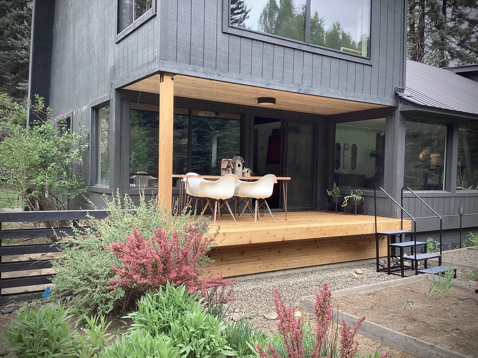 Finished deck with railing overlooking wooded property